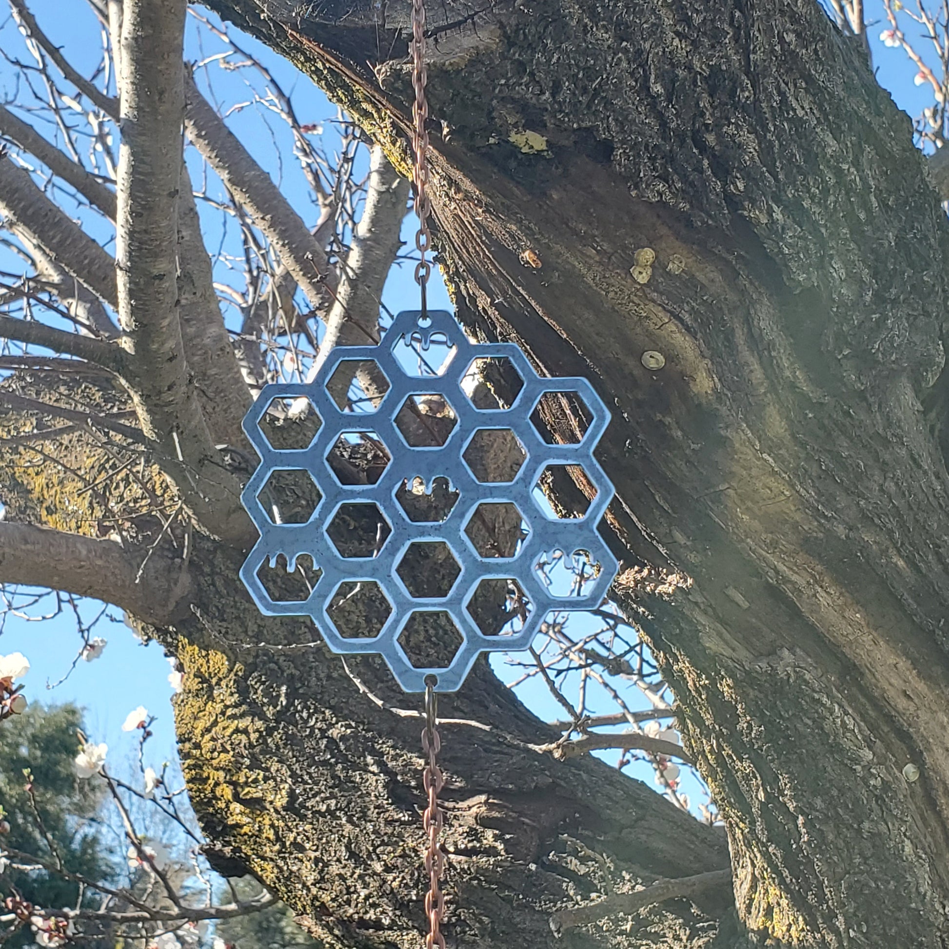 Front view of the honeycomb wind spinner in raw unfinished steel, symmetrically designed 
